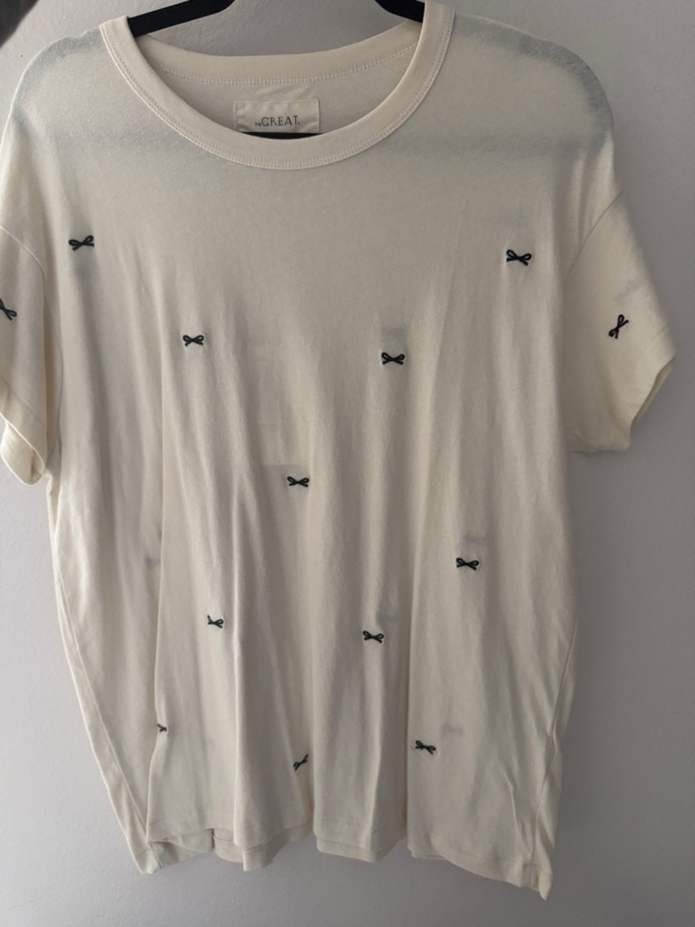 THE GREAT. Cream Short Sleeve Tee with Black Bow Embroidery